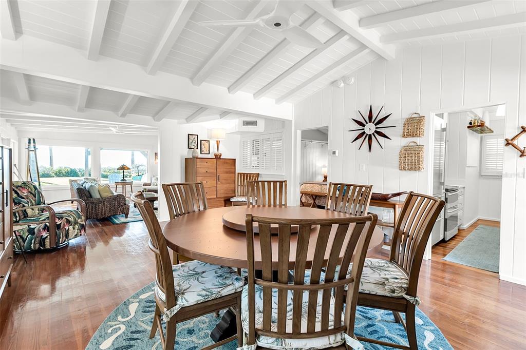 621 Casey Key Road Nokomis, FL 34275 - Photo 26 of 51 a view of a dining room with furniture and wooden floor