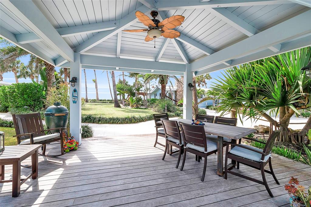 621 Casey Key Road Nokomis, FL 34275 - Photo 27 of 51 a patio with yard glass top table and chairs