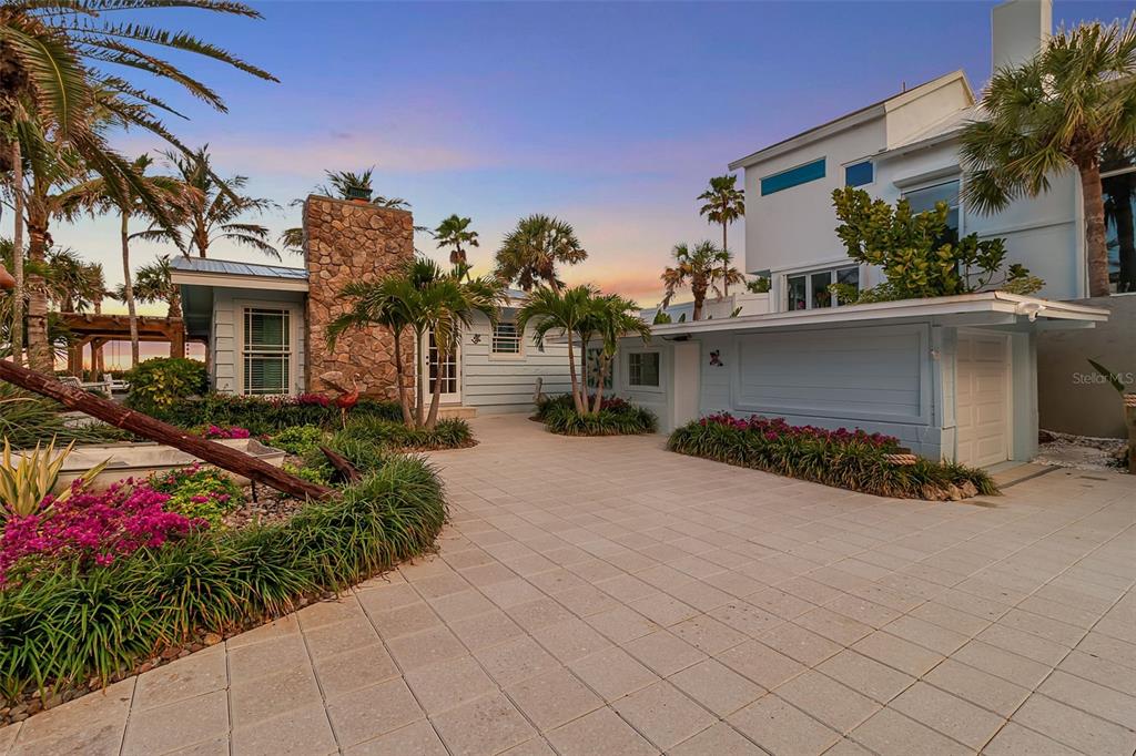 621 Casey Key Road Nokomis, FL 34275 - Photo 44 of 51 a front view of a house with a yard and a garage