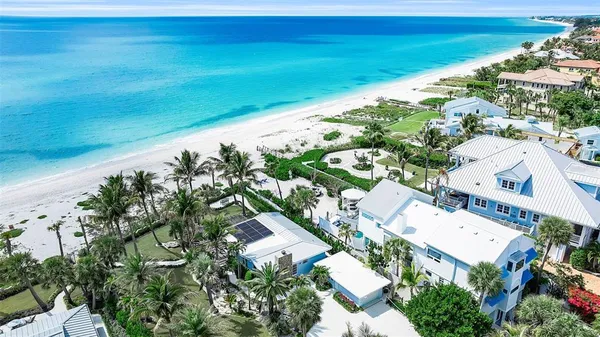 a view of a patio with table and chairs potted plants and palm trees