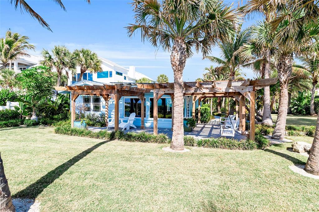 621 Casey Key Road Nokomis, FL 34275 - Photo 50 of 51 a view of a house with a patio and a yard