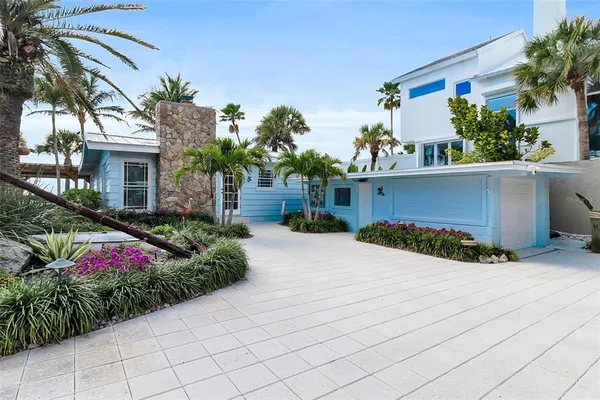 a front view of a house with a yard and a garage