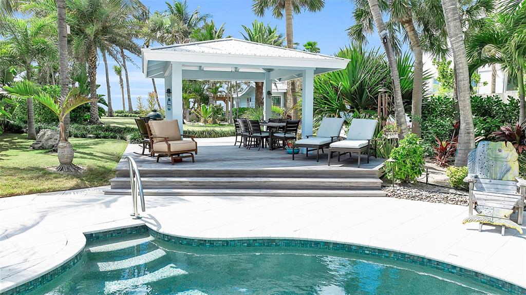 621 Casey Key Road Nokomis, FL 34275 - Photo 10 of 51 a view of a house with backyard swimming pool and sitting area