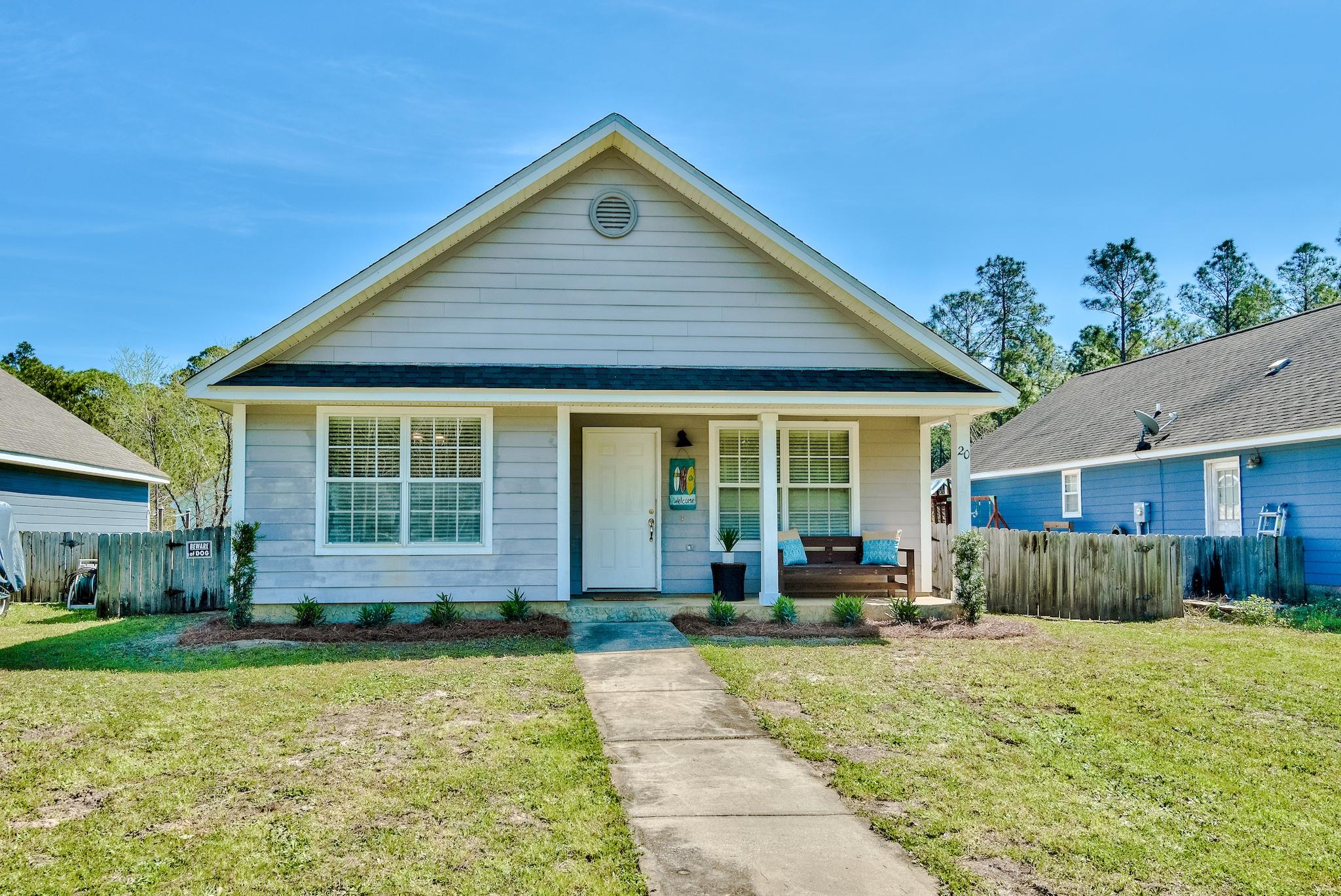 a front view of a house with a yard outdoor seating and barbeque oven