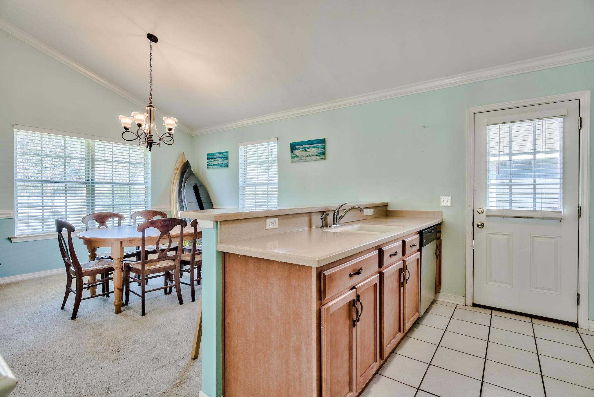 20 4th Street Santa Rosa Beach, FL 32459 - Photo 10 of 41 a view of a dining room and livingroom with furniture wooden floor a chandelier