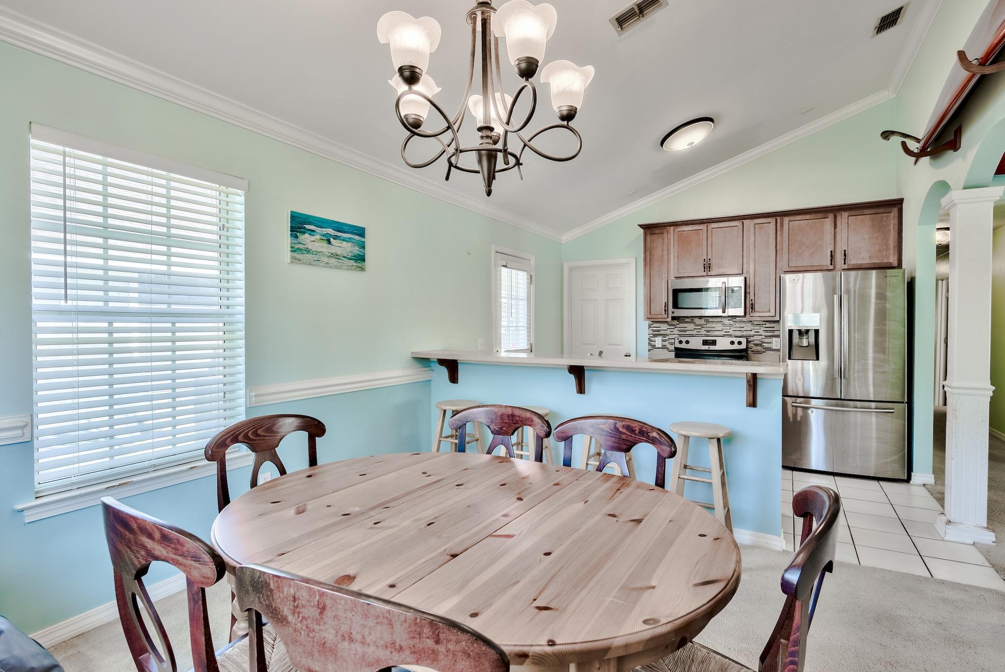 20 4th Street Santa Rosa Beach, FL 32459 - Photo 11 of 41 a kitchen with stainless steel appliances granite countertop a dining table and chairs
