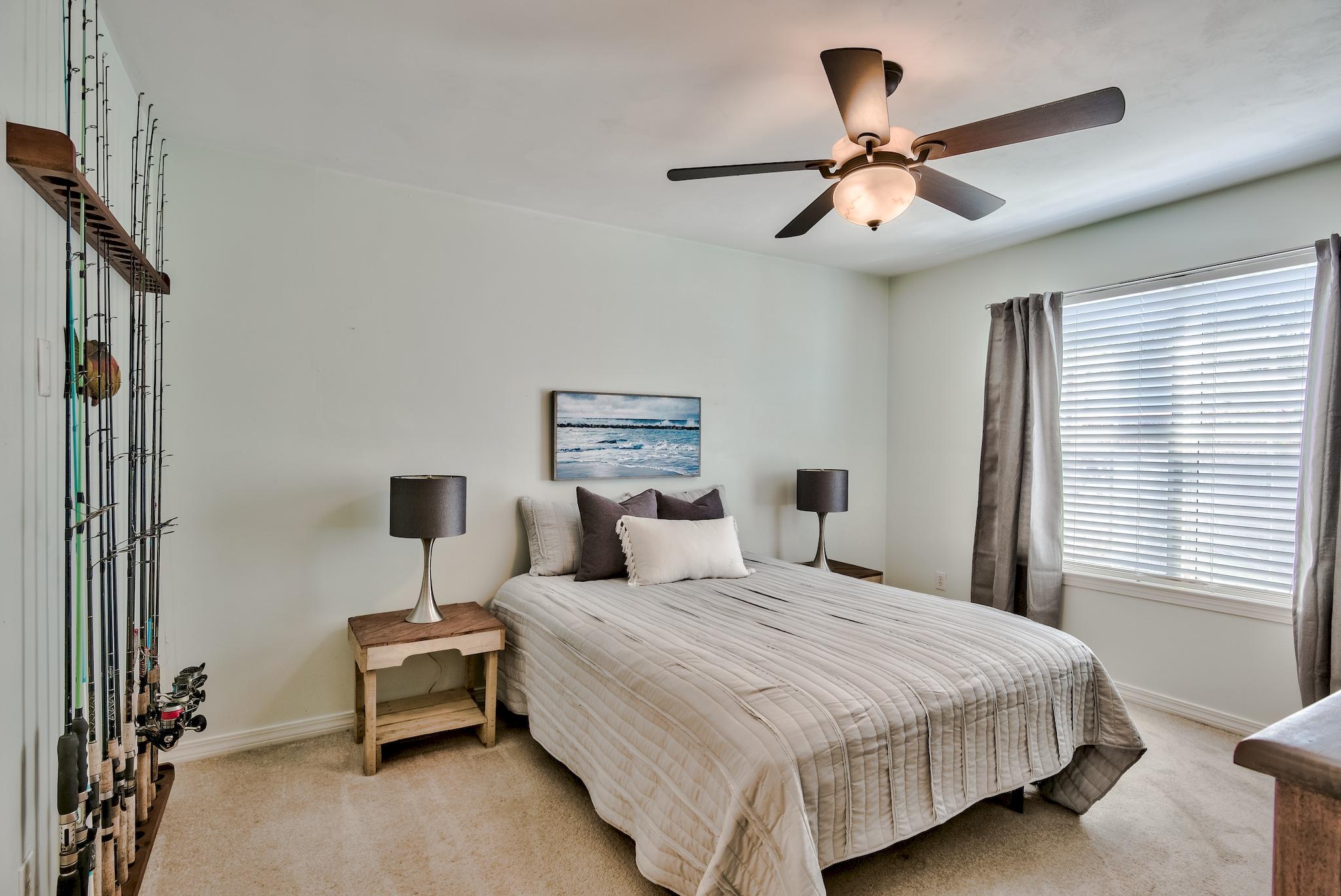 20 4th Street Santa Rosa Beach, FL 32459 - Photo 13 of 41 a bedroom with a bed and a chandelier