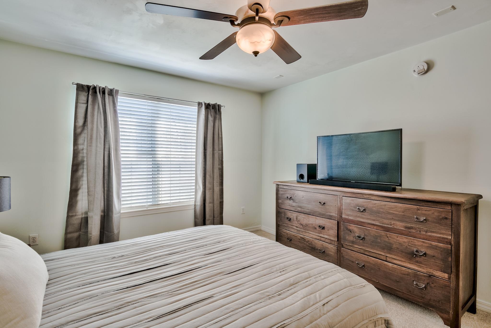20 4th Street Santa Rosa Beach, FL 32459 - Photo 14 of 41 a bedroom with a bed and a flat screen tv