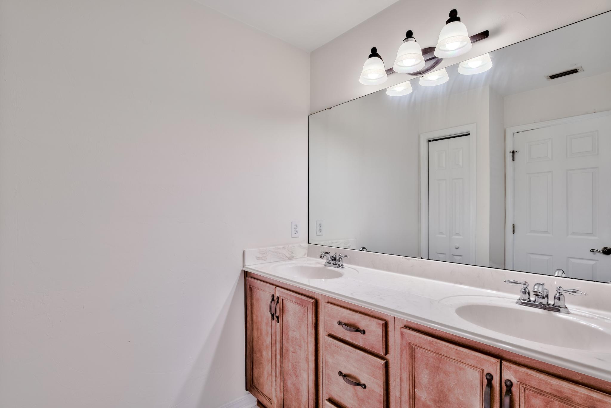 20 4th Street Santa Rosa Beach, FL 32459 - Photo 16 of 41 a bathroom with a sink vanity and a mirror