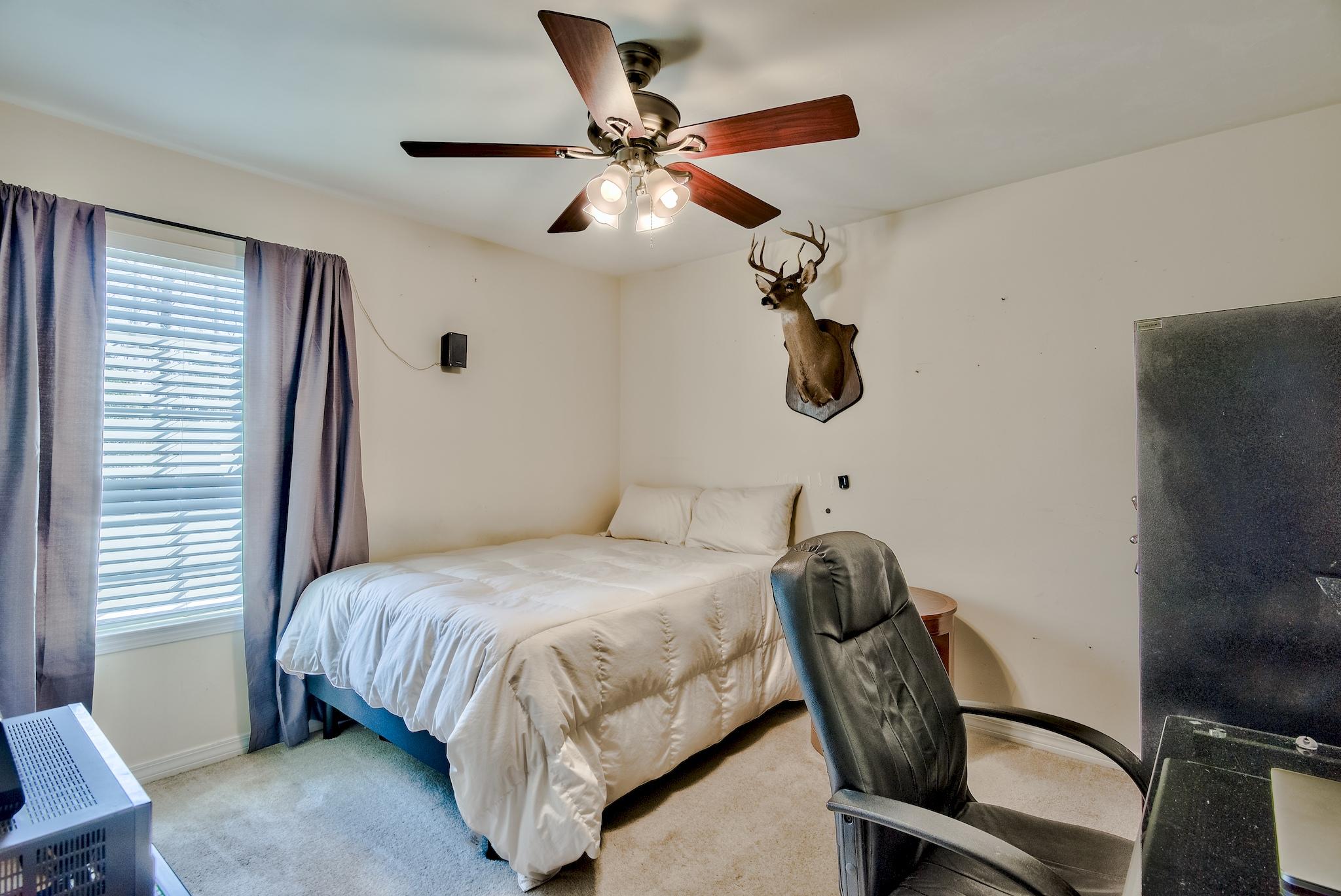 20 4th Street Santa Rosa Beach, FL 32459 - Photo 17 of 41 a bedroom with a bed and a chandelier