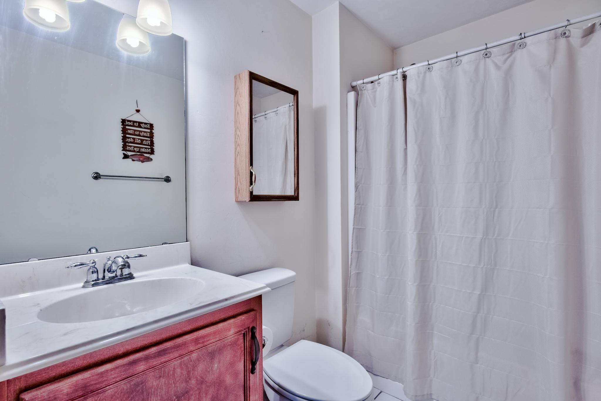 20 4th Street Santa Rosa Beach, FL 32459 - Photo 19 of 41 a bathroom with a sink vanity mirror and toilet