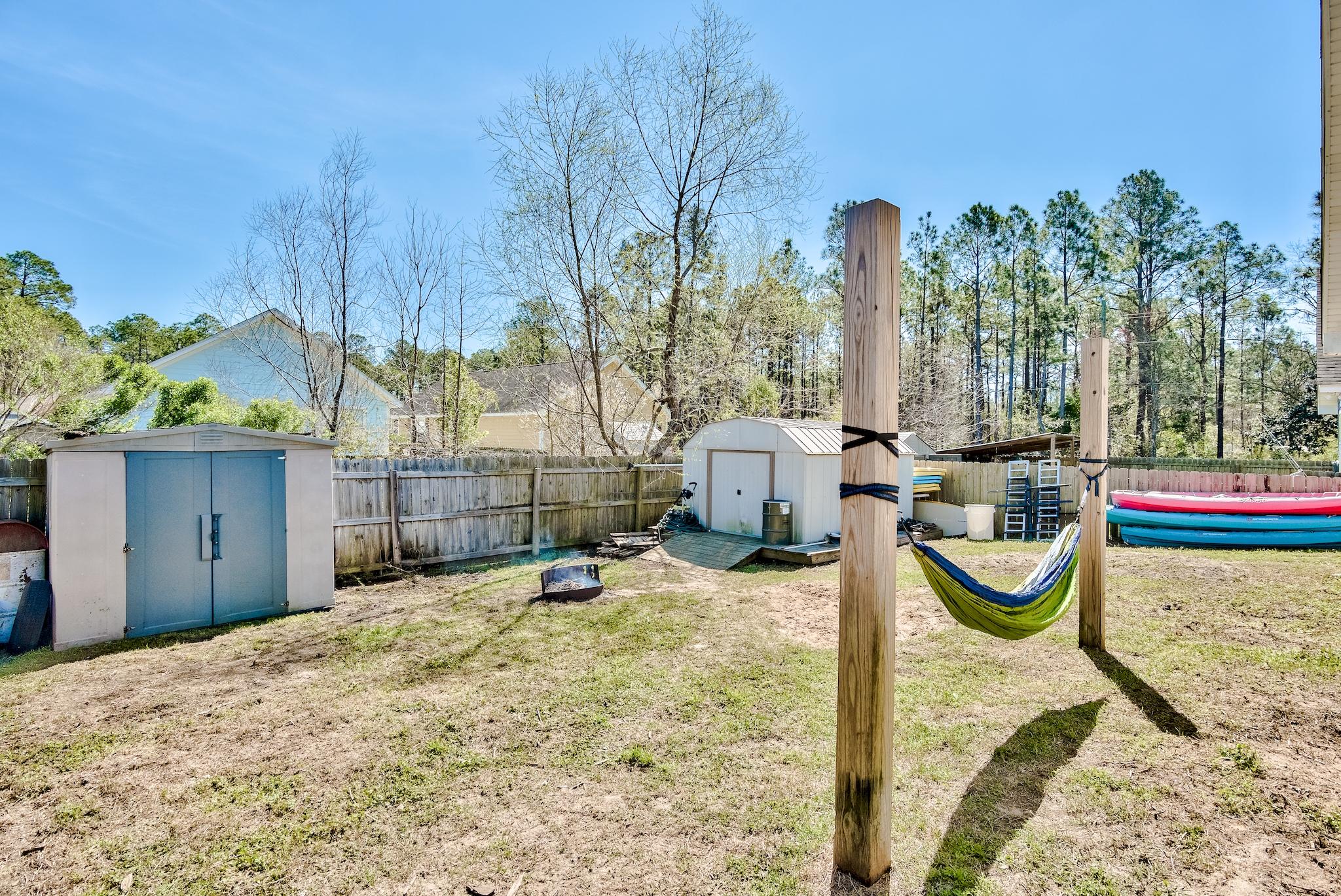 20 4th Street Santa Rosa Beach, FL 32459 - Photo 23 of 41 a backyard of a house with table and chairs