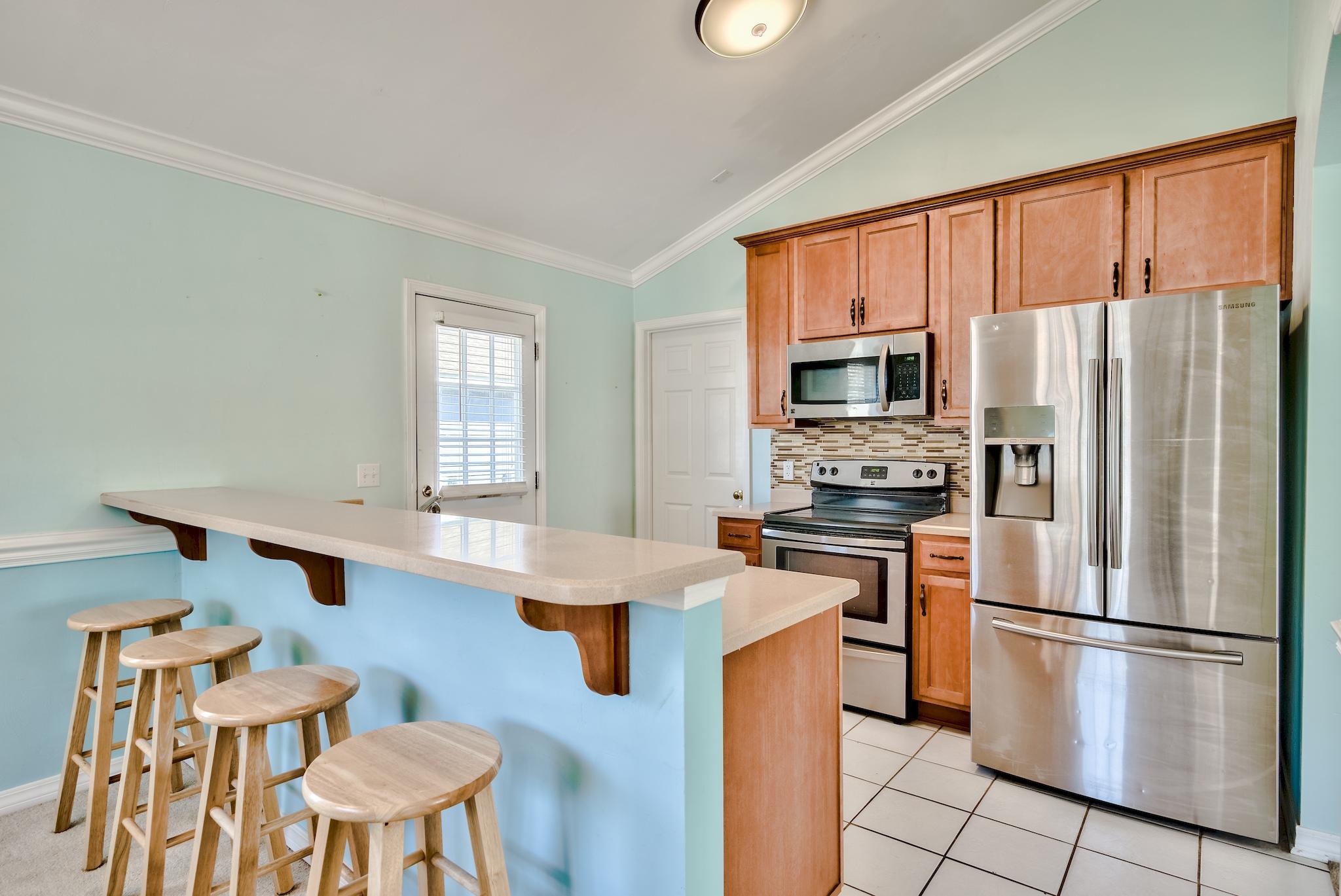 20 4th Street Santa Rosa Beach, FL 32459 - Photo 7 of 41 a kitchen with stainless steel appliances a refrigerator stove microwave and cabinets