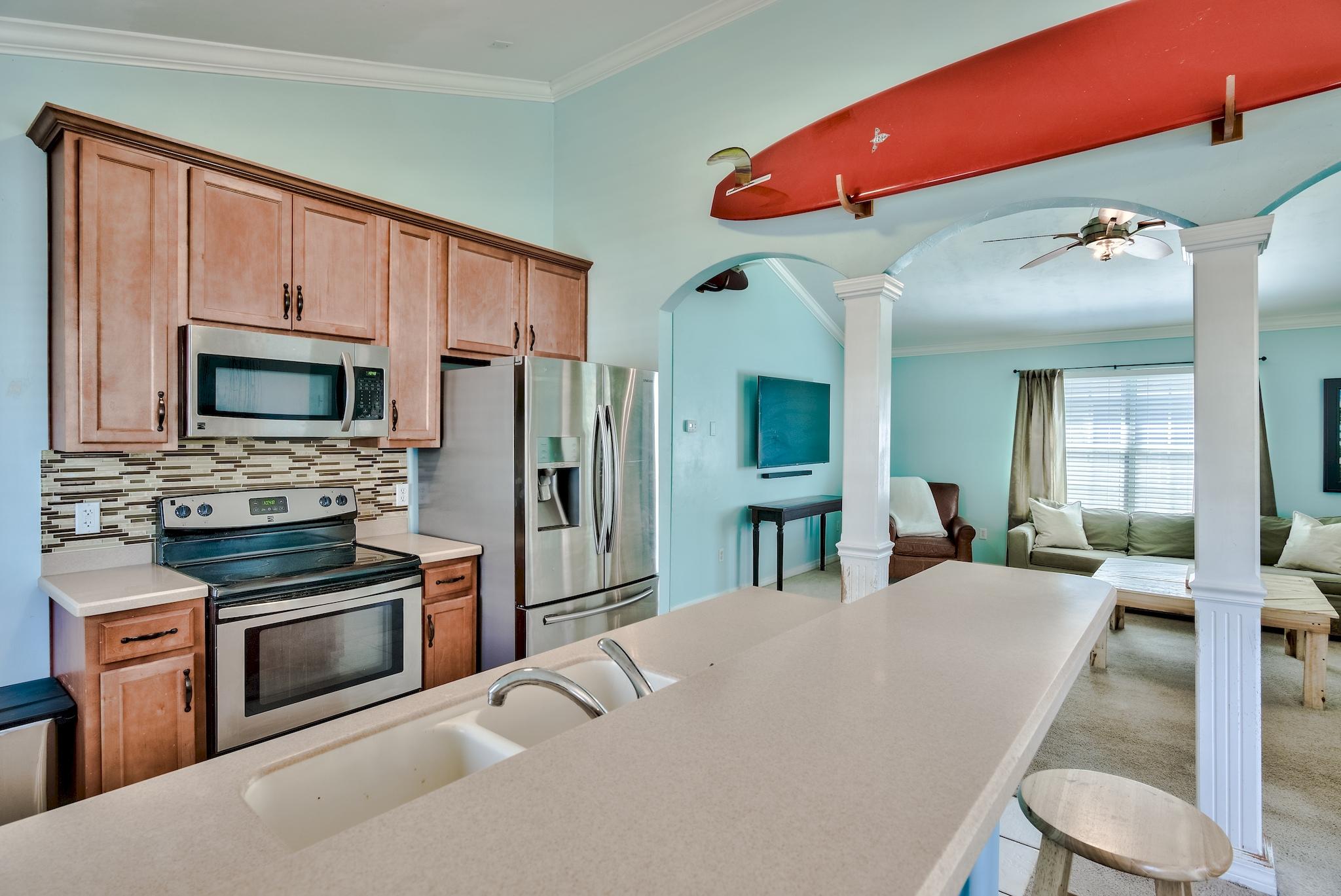 20 4th Street Santa Rosa Beach, FL 32459 - Photo 8 of 41 a large kitchen with stainless steel appliances a stove a refrigerator a oven with white cabinets and wooden floor