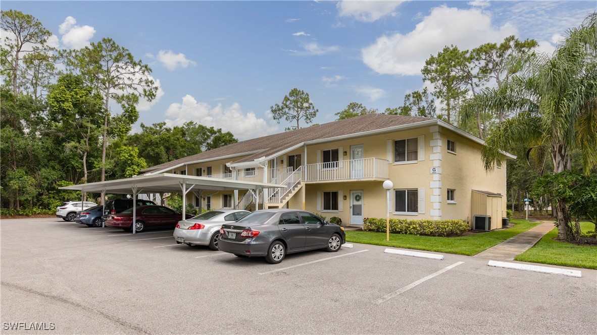 3451 County Barn Road, Unit G103 Naples, FL 34112 - Photo 1 of 25 a car parked in front of a house