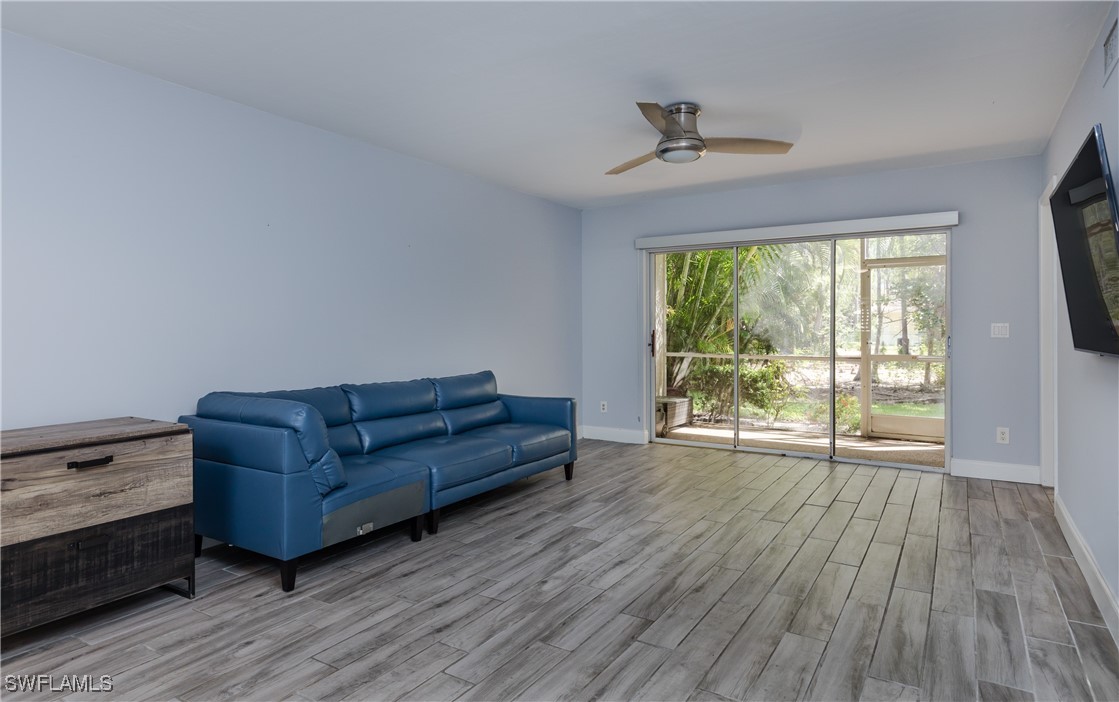 3451 County Barn Road, Unit G103 Naples, FL 34112 - Photo 12 of 25 a living room with couch and a large window