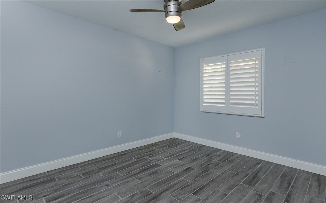 3451 County Barn Road, Unit G103 Naples, FL 34112 - Photo 17 of 25 wooden floor in an empty room with a window