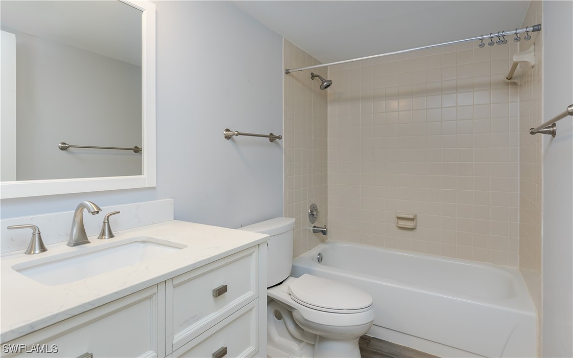 3451 County Barn Road, Unit G103 Naples, FL 34112 - Photo 18 of 25 a bathroom with a sink toilet and shower