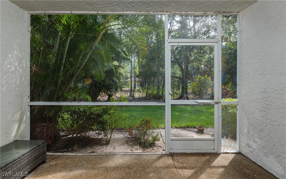 3451 County Barn Road, Unit G103 Naples, FL 34112 - Photo 20 of 25 a couple of potted plants in front of a yard