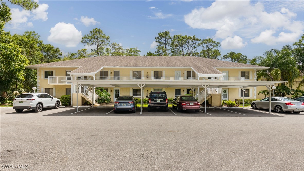 3451 County Barn Road, Unit G103 Naples, FL 34112 - Photo 2 of 25 a view of a cars parked in front of a building