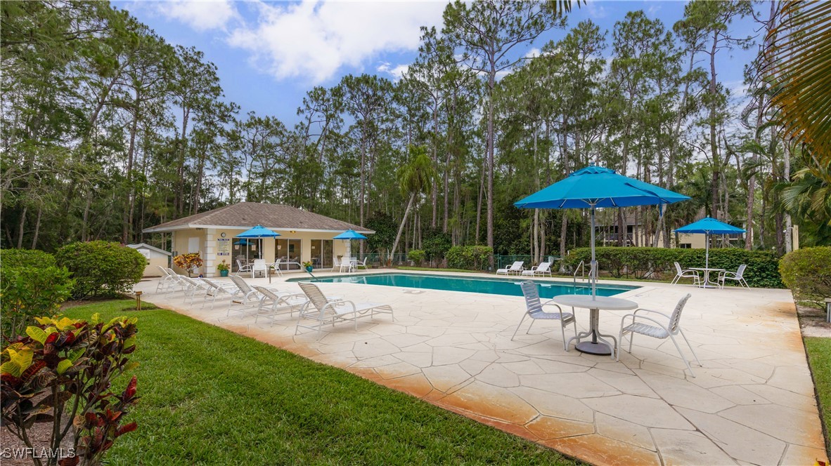 3451 County Barn Road, Unit G103 Naples, FL 34112 - Photo 22 of 25 a garden view with a seating space