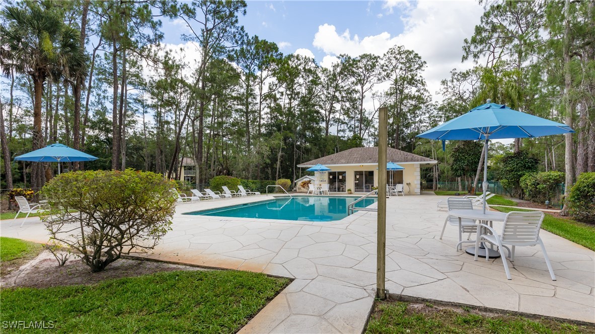 3451 County Barn Road, Unit G103 Naples, FL 34112 - Photo 24 of 25 a view of a patio with furniture and a yard
