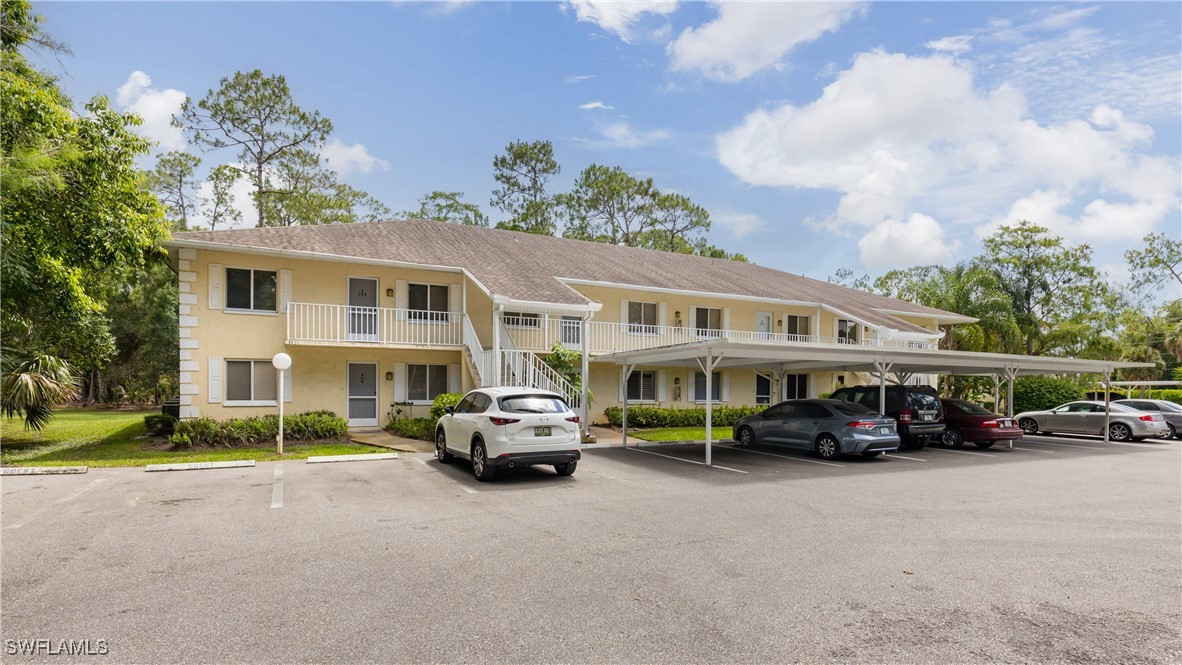 3451 County Barn Road, Unit G103 Naples, FL 34112 - Photo 3 of 25 a car parked in front of a building