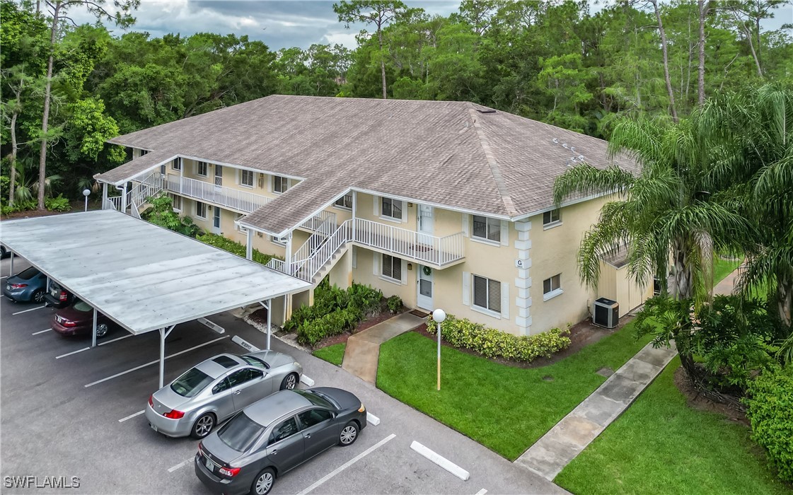 3451 County Barn Road, Unit G103 Naples, FL 34112 - Photo 4 of 25 a aerial view of a house with a yard table and chairs