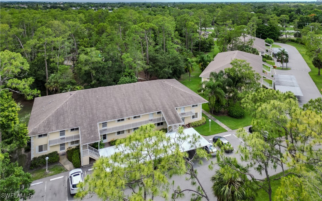 3451 County Barn Road, Unit G103 Naples, FL 34112 - Photo 6 of 25 an aerial view of a house with a garden and plants