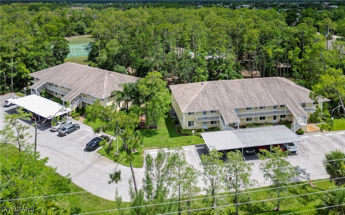 3451 County Barn Road, Unit G103 Naples, FL 34112 - Photo 7 of 25 an aerial view of a house with yard and outdoor seating