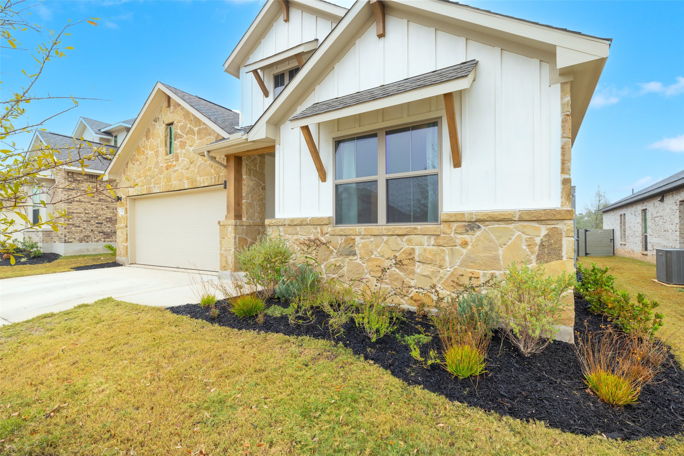 1117 Spring Gulch Lane Georgetown, TX 78628 - Photo 3 of 39 Crafted with elegant stone and board-and-batten siding, this home presents inviting curb appeal.