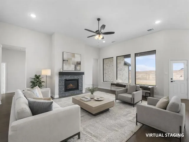 a living room with furniture and a fireplace