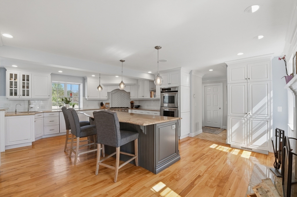 183 Whiting Street Hanover, MA 02339 - Photo 6 of 42 a large kitchen with a table and chairs