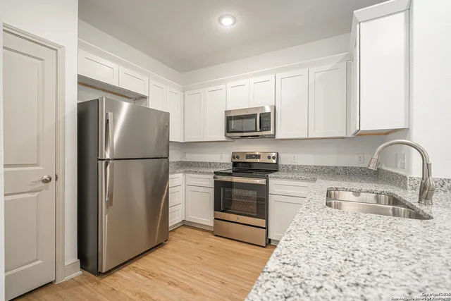 a kitchen with a refrigerator stove and sink