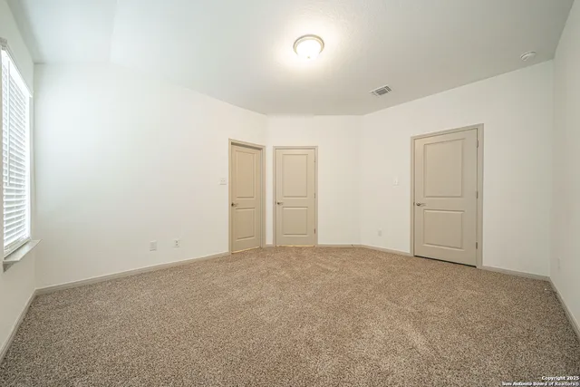 an empty room with windows and closet