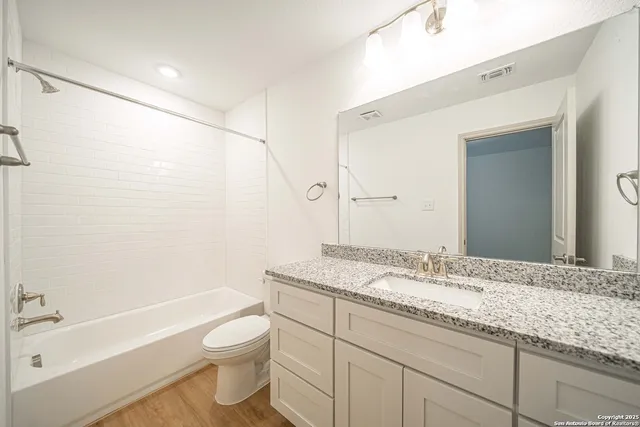 a bathroom with a sink and mirror