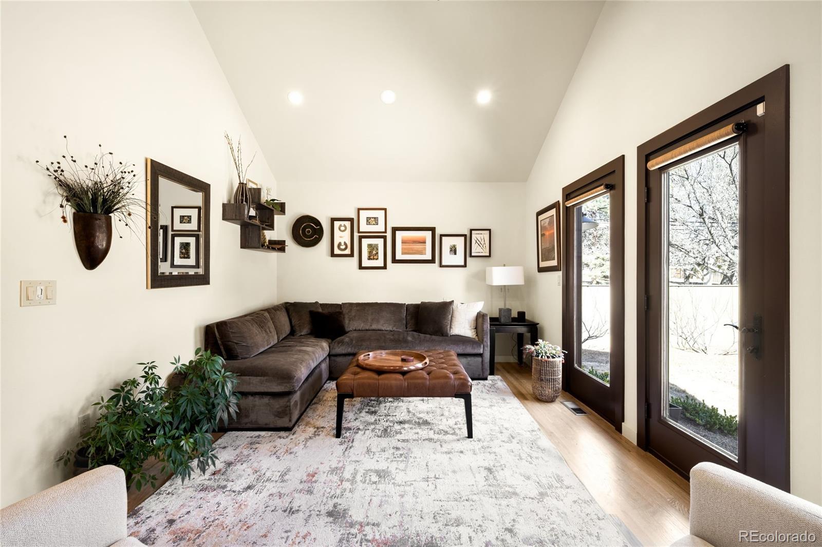 790 Clayton Street Denver, CO 80206 - Photo 11 of 32 a living room with furniture and a window