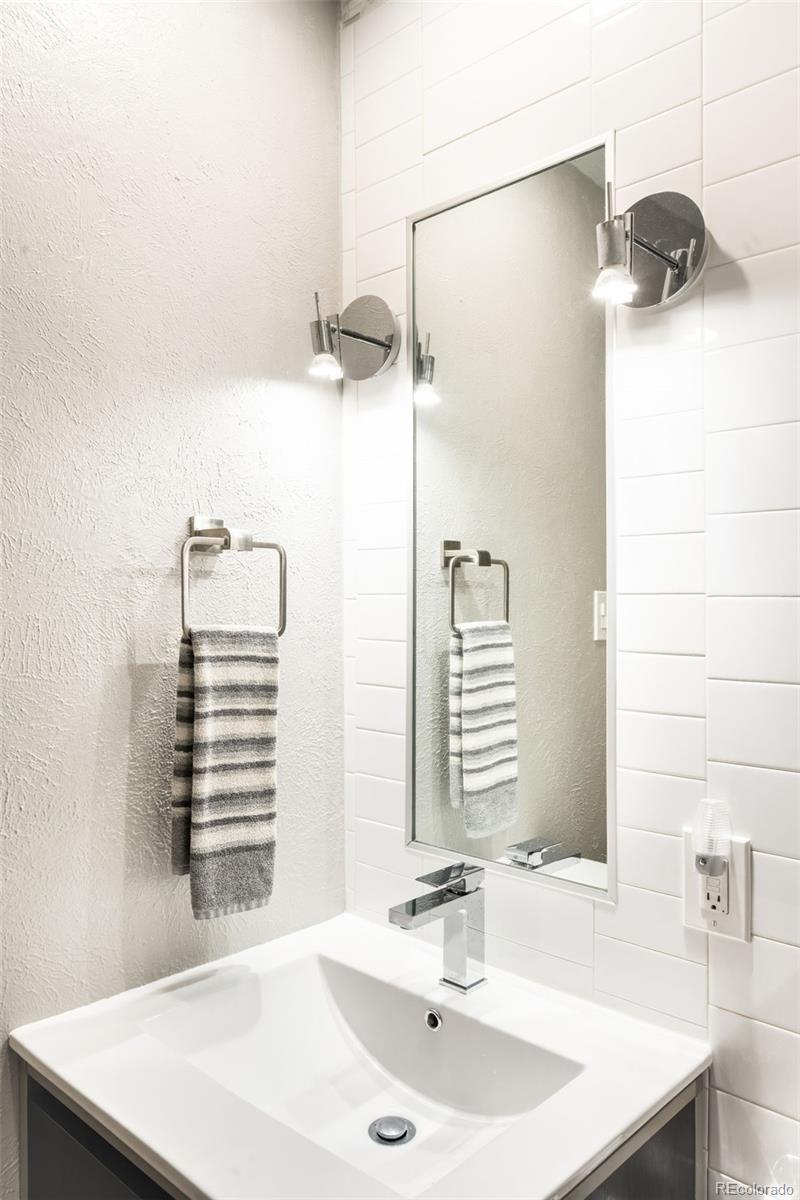 790 Clayton Street Denver, CO 80206 - Photo 14 of 32 a bathroom with a sink and a mirror