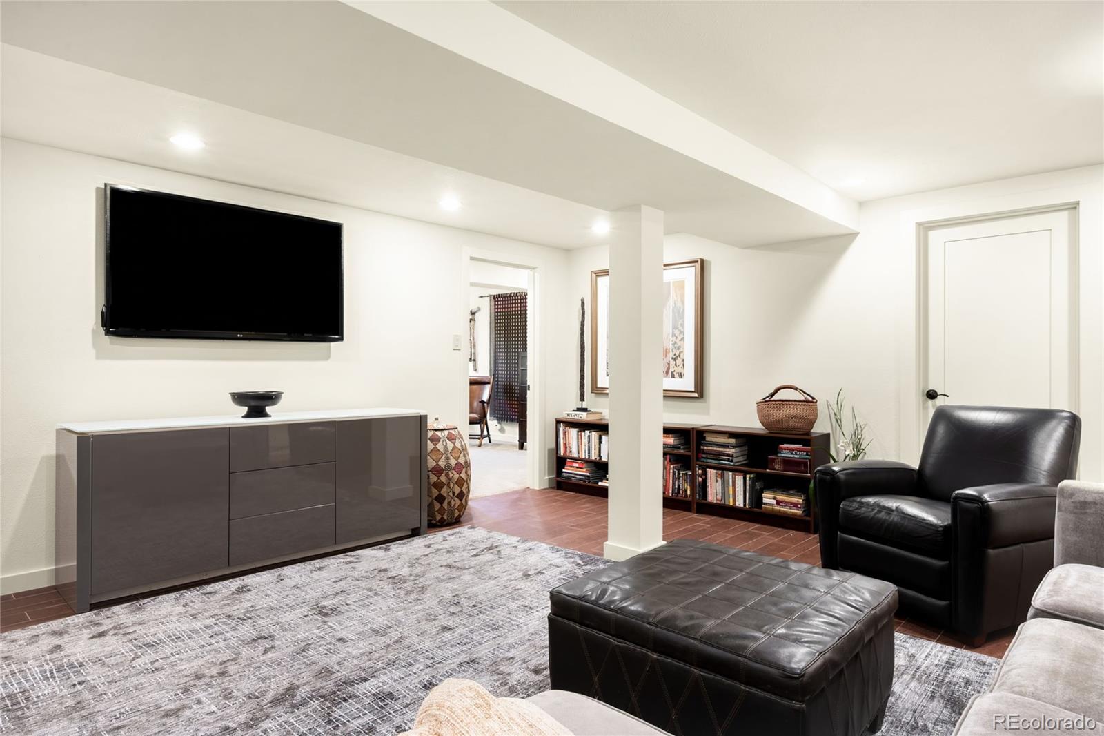 790 Clayton Street Denver, CO 80206 - Photo 20 of 32 a living room with furniture and a flat screen tv