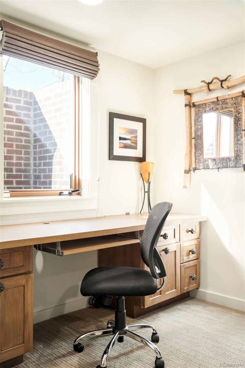 790 Clayton Street Denver, CO 80206 - Photo 22 of 32 a view of a workspace with furniture and a window