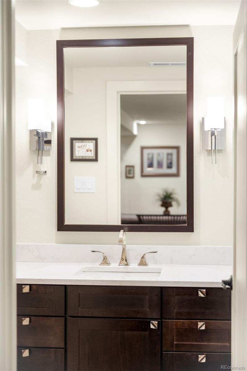 790 Clayton Street Denver, CO 80206 - Photo 25 of 32 a bathroom with a sink and a mirror