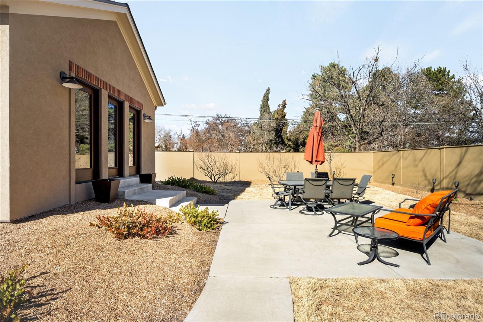 790 Clayton Street Denver, CO 80206 - Photo 30 of 32 a backyard of a house with outdoor seating