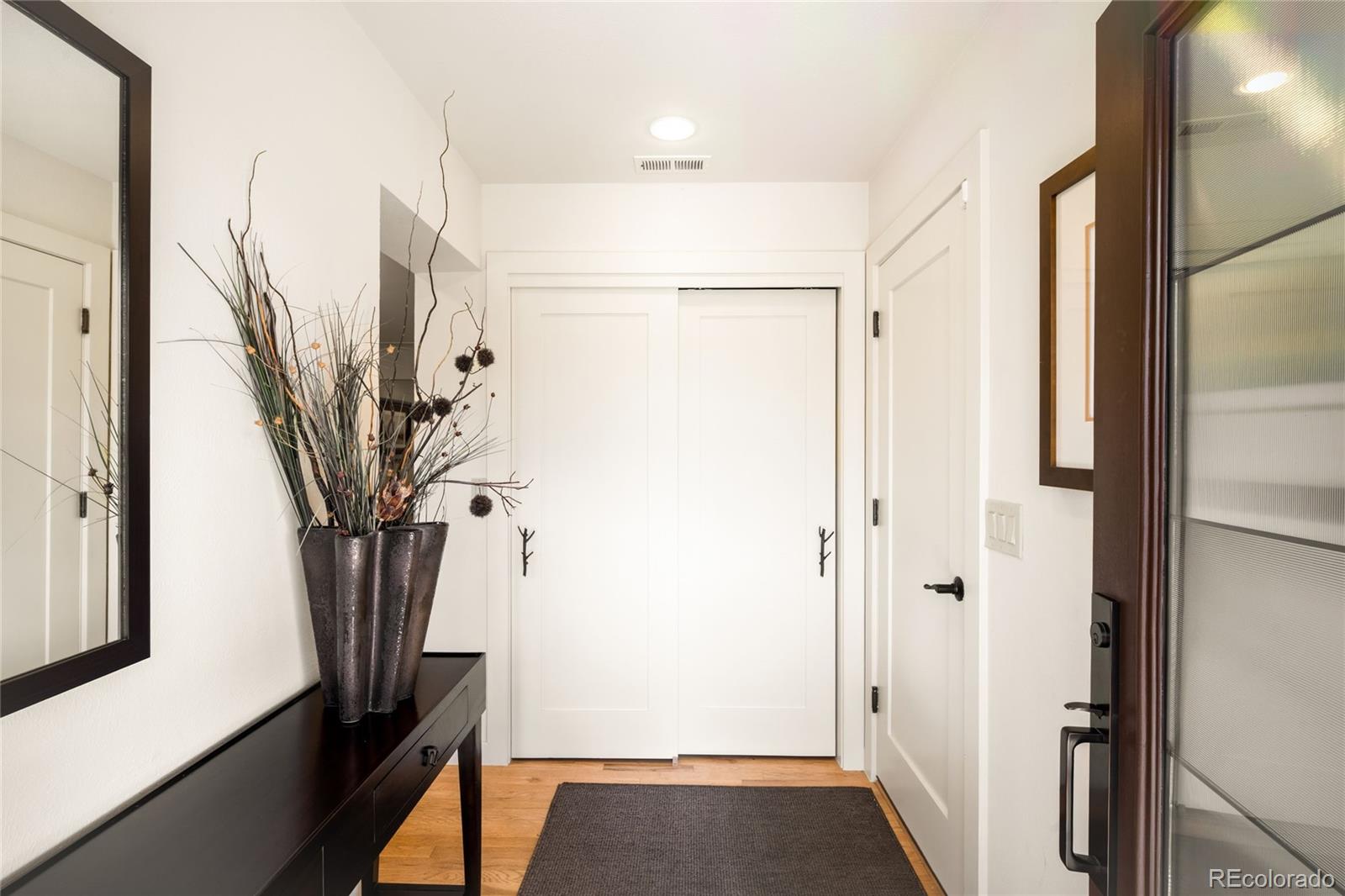790 Clayton Street Denver, CO 80206 - Photo 32 of 32 a view of a hallway with a window
