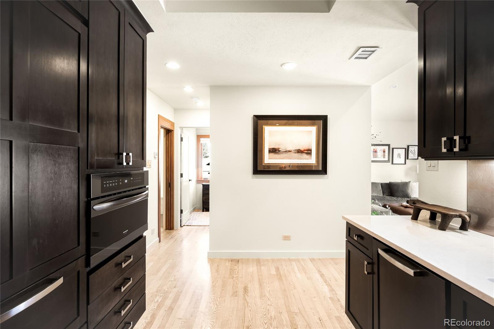 790 Clayton Street Denver, CO 80206 - Photo 9 of 32 a kitchen with a refrigerator and a stove top oven