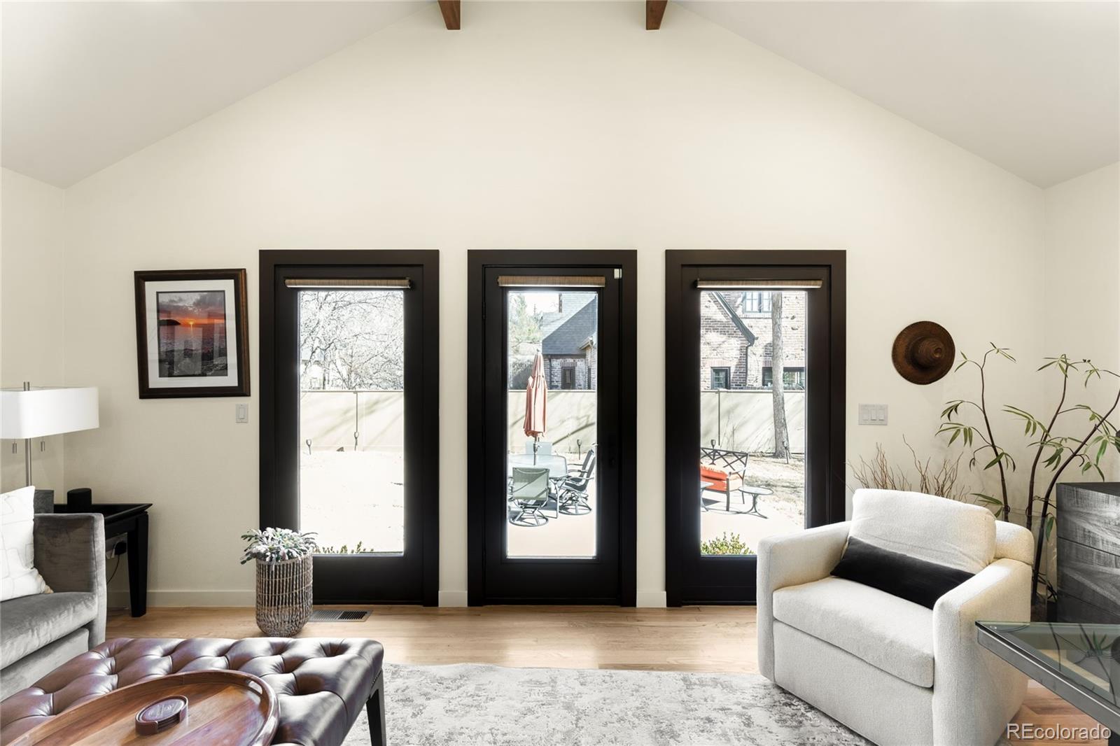 790 Clayton Street Denver, CO 80206 - Photo 10 of 32 a living room with furniture and a large window