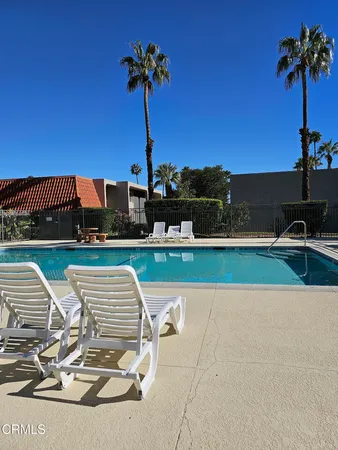 a roof deck with table and chairs