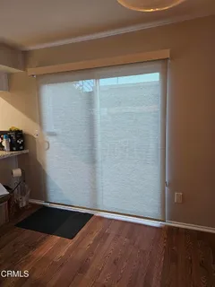 a view of a small space with wooden floor and a sink