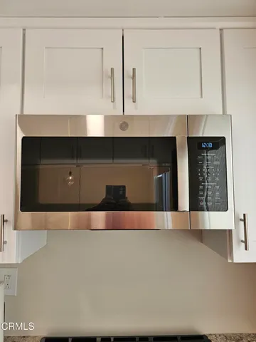a view of wooden floor and cabinets in a kitchen