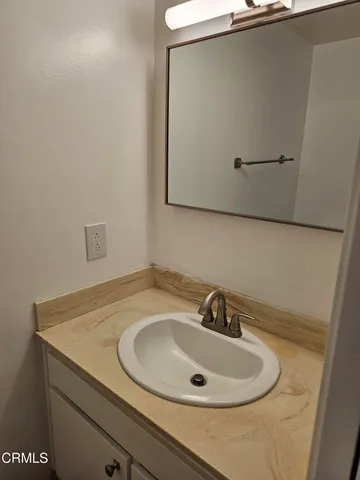 a bathroom with a sink and mirror