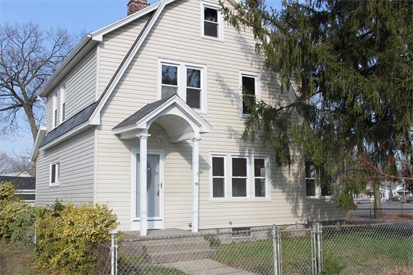 a view of a white house next to a yard